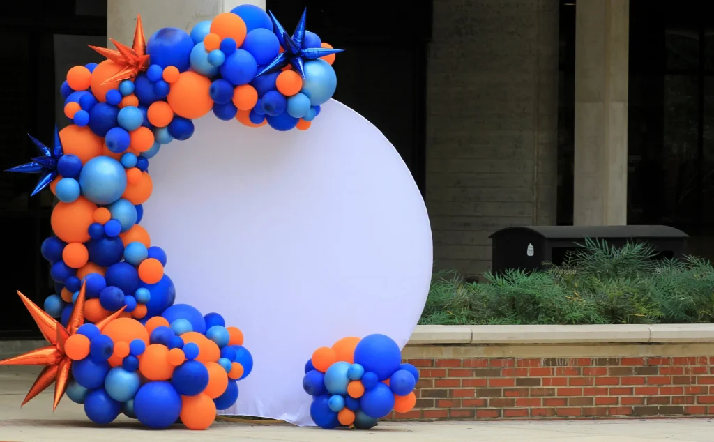 A blue and orange balloon photo backdrop display