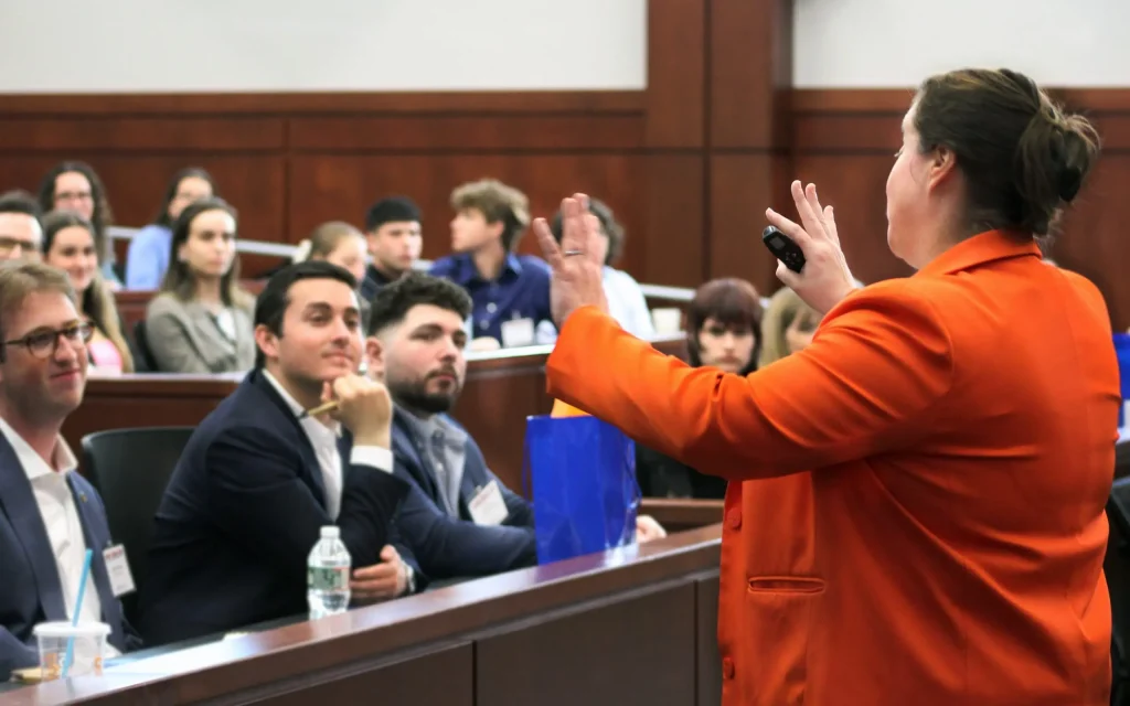 An individual addressing attendees at an event
