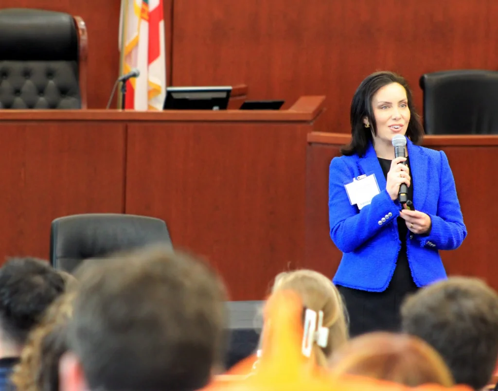 An individual addressing attendees at an event