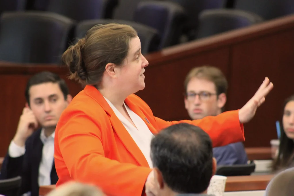 An individual addressing attendees at an event