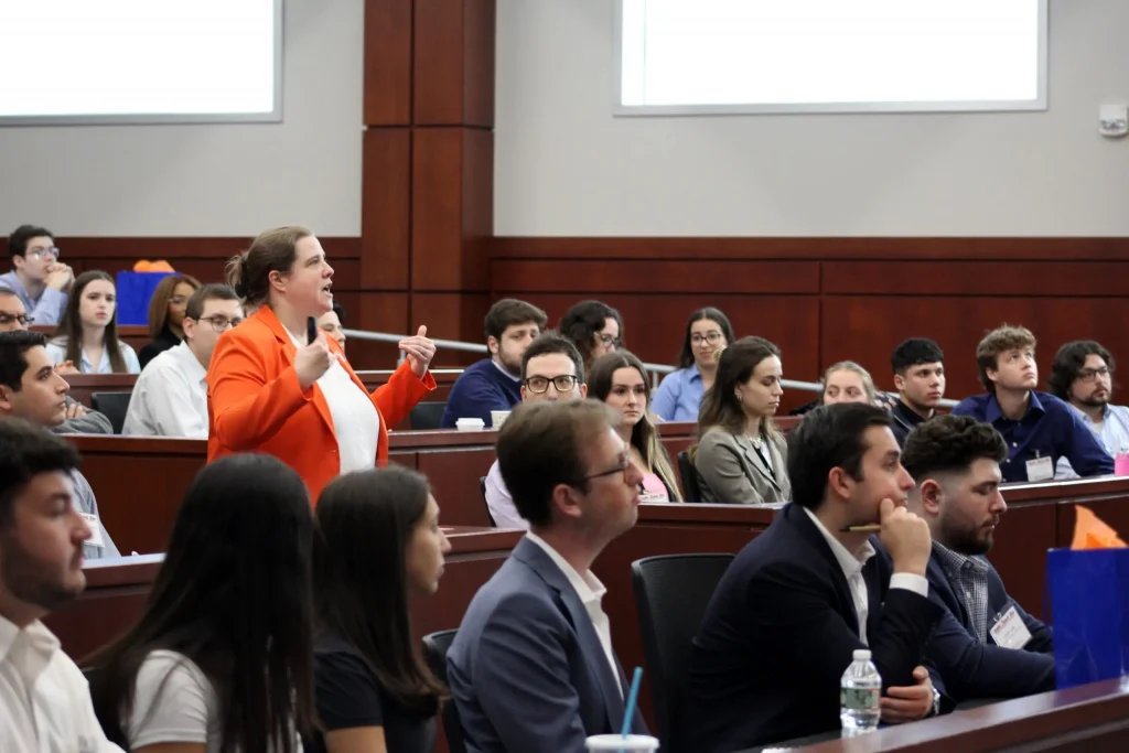 An individual addressing attendees at an event