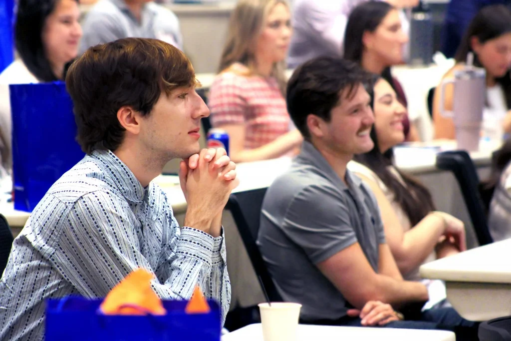 Event attendees listen to a presentation