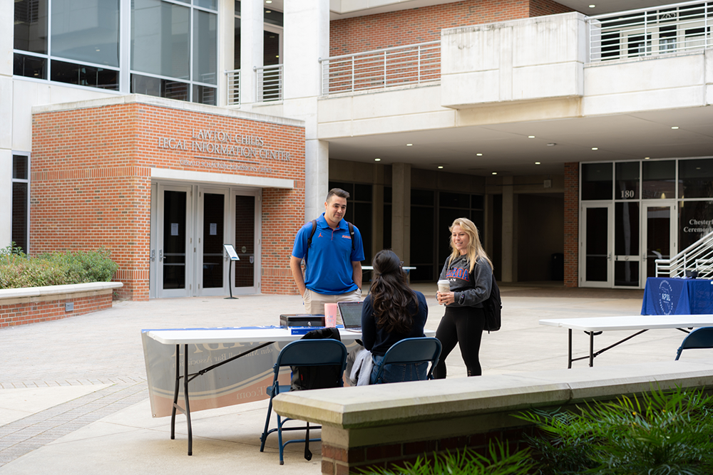 A small group of students converse in the courtyard