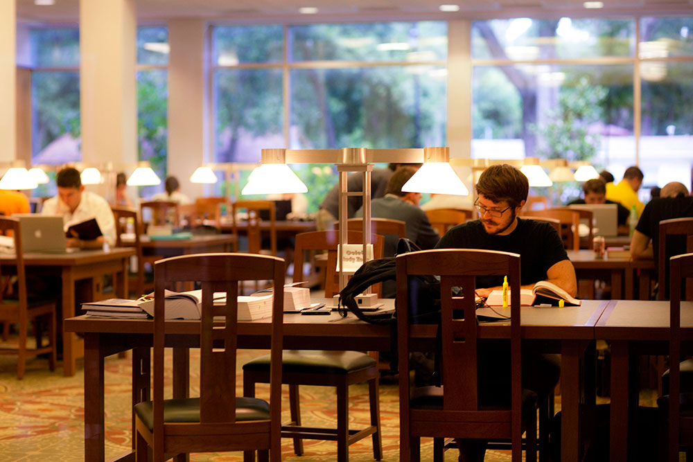 Students studying at tables in the library