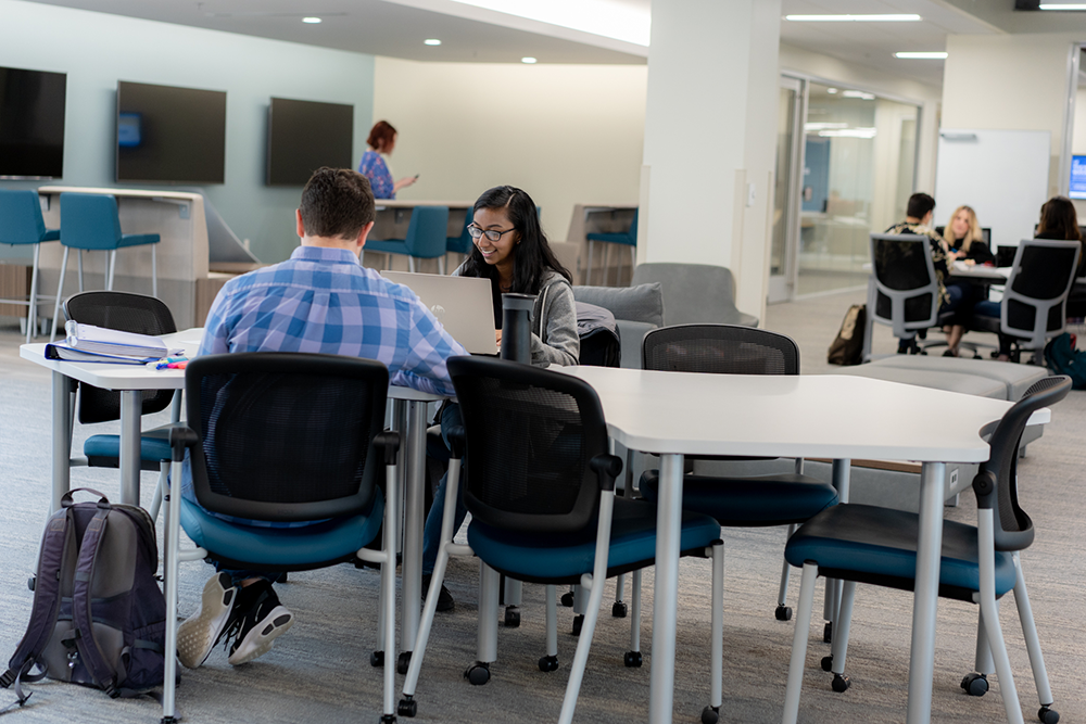 Students sitting at t a table studying in the Student Life Center