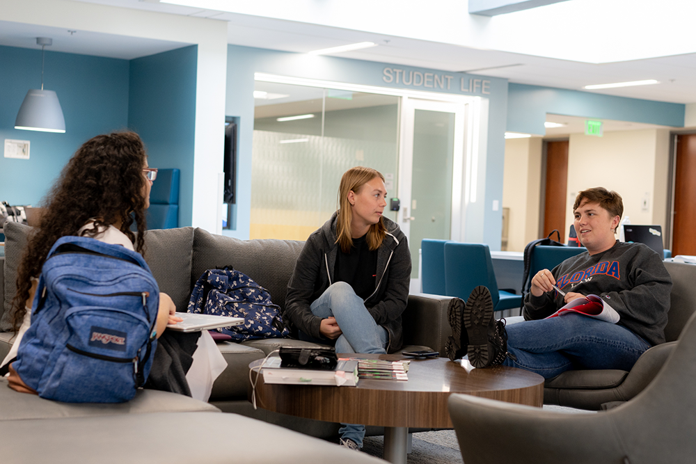 Three students socializing in the Student Life Center
