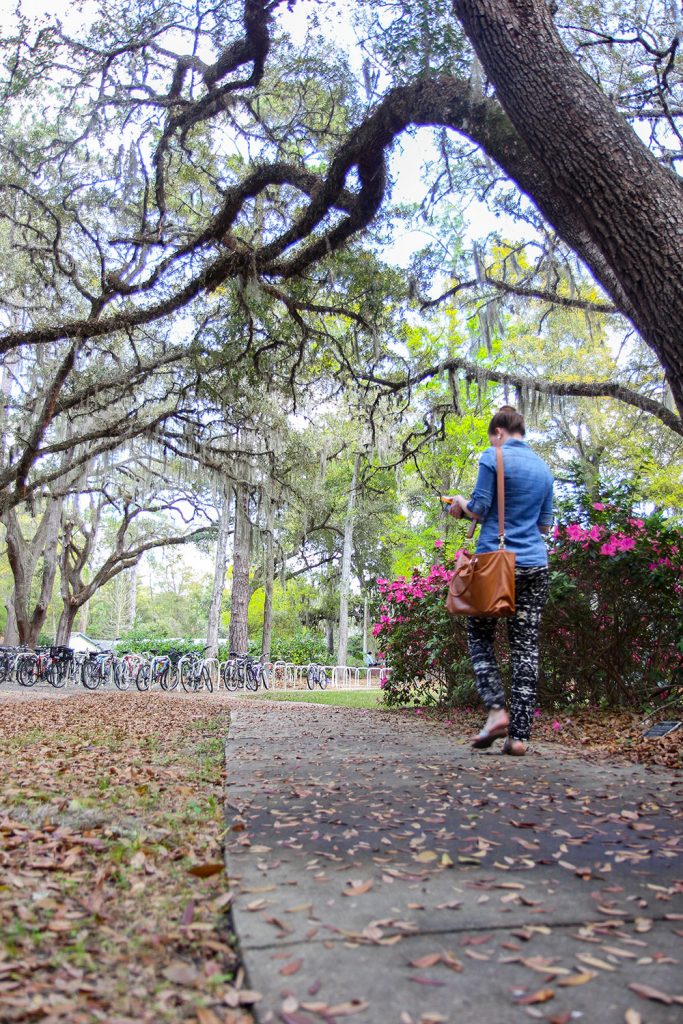 A student walks along the Walking Trail