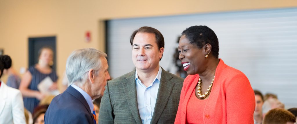 3 UF Law alumni greeting each other