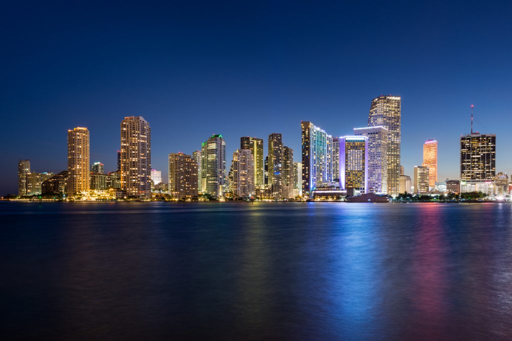 Illuminated Miami skyline at dusk