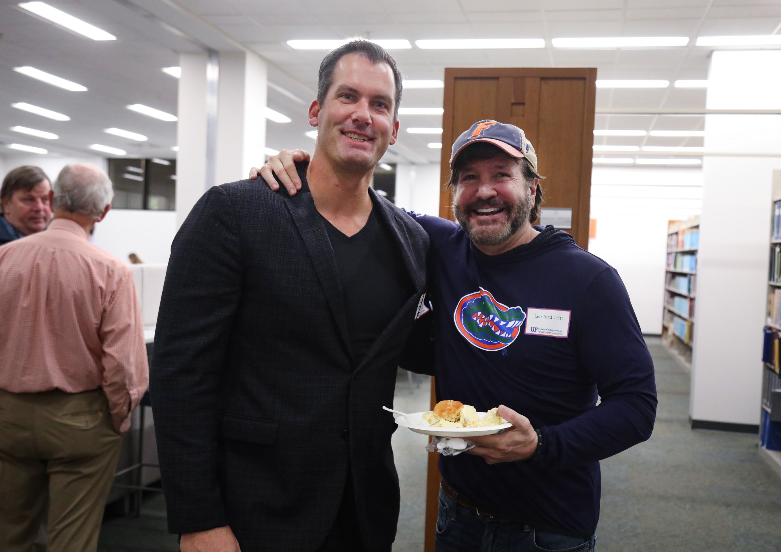 Two guests pose for a photo at the brunch hosted at UF Law in celebration of Professor Dennis Calfee and his 50 years of service to the law school on November 16.