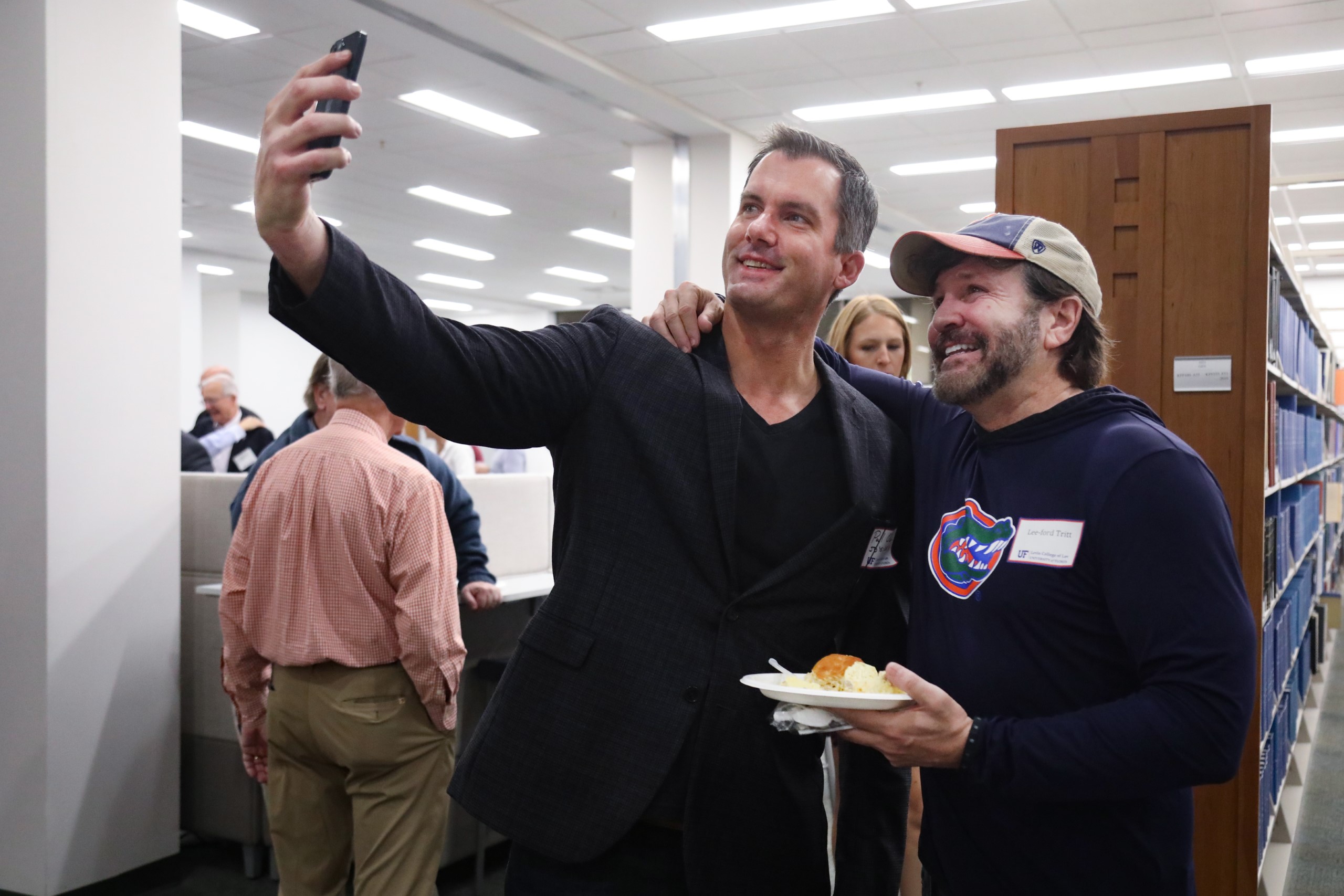 Two guests pose for a photo at the brunch hosted at UF Law in celebration of Professor Dennis Calfee and his 50 years of service to the law school on November 16.
