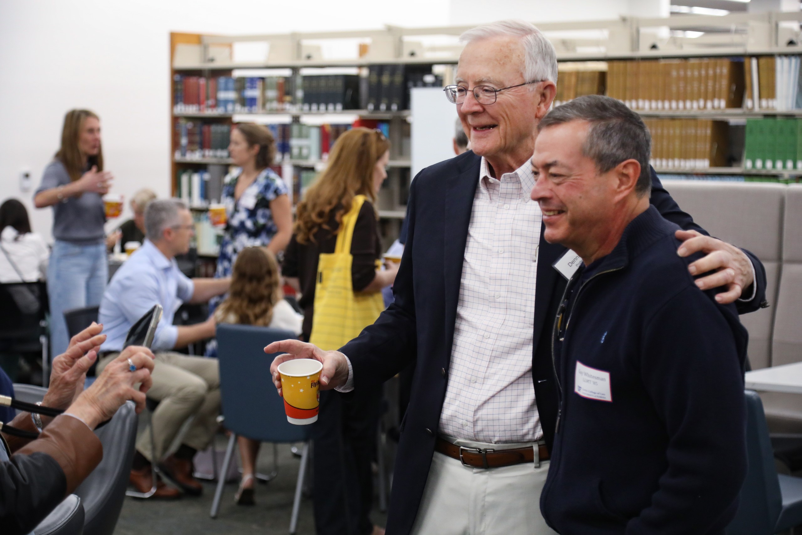 Professor Dennis Calfee poses with guests at a celebratory brunch hosted at UF Law in honor of his 50 years of service to the law school on November 16.