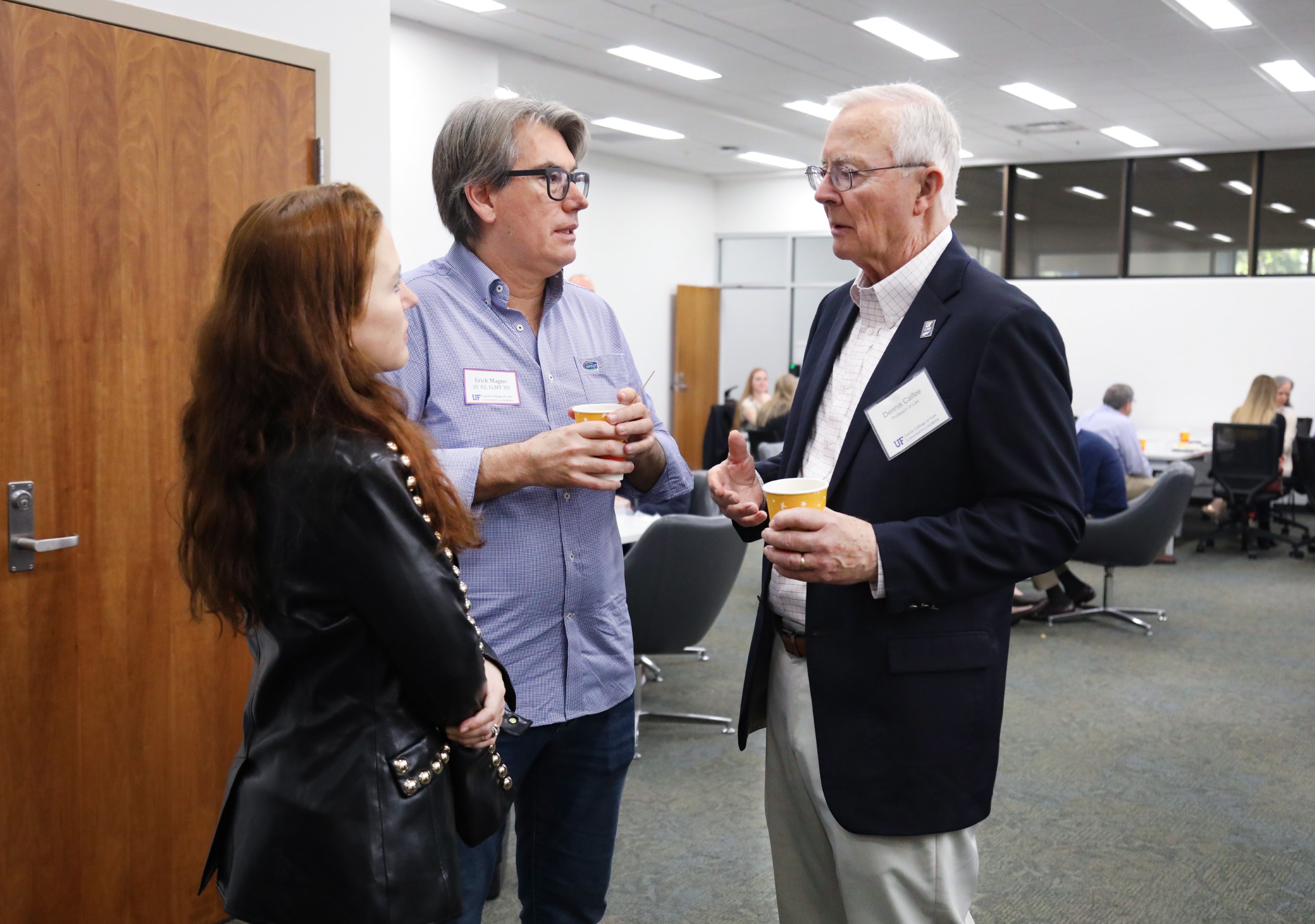 Professor Dennis Calfee talks with guests at a celebratory brunch hosted at UF Law in honor of his 50 years of service to the law school on November 16.