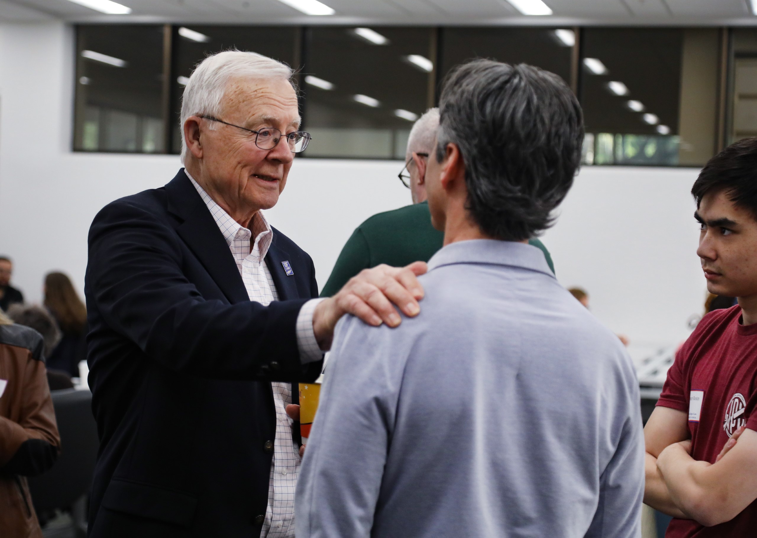 Professor Dennis Calfee talks with guests at a celebratory brunch hosted at UF Law in honor of his 50 years of service to the law school on November 16.