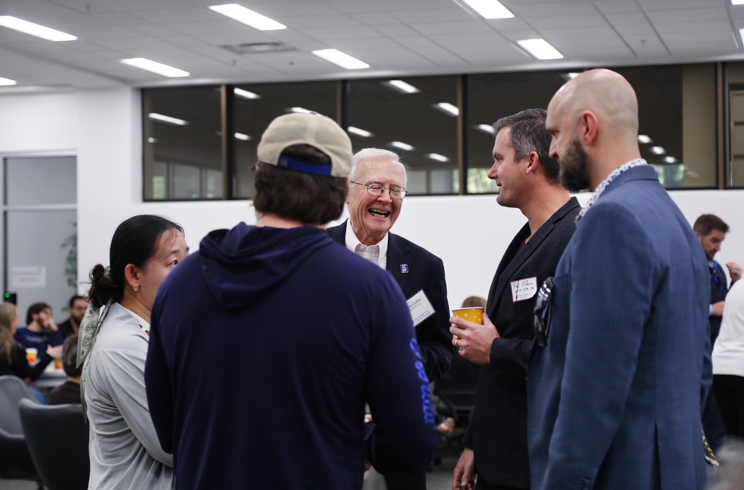 Professor Dennis Calfee talks with guests at a celebratory brunch hosted at UF Law in honor of his 50 years of service to the law school on November 16.