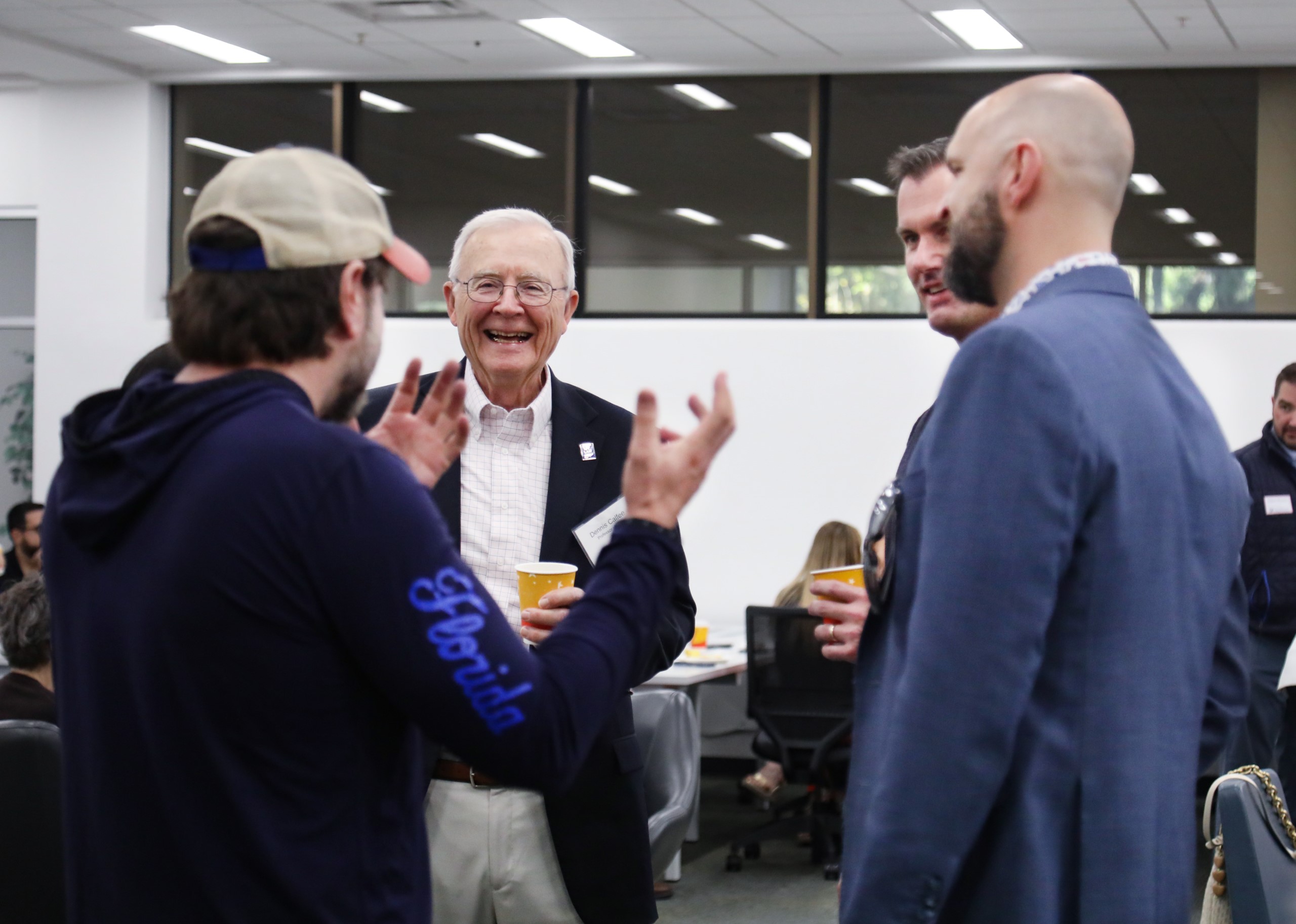 Professor Dennis Calfee talks with guests at a celebratory brunch hosted at UF Law in honor of his 50 years of service to the law school on November 16.