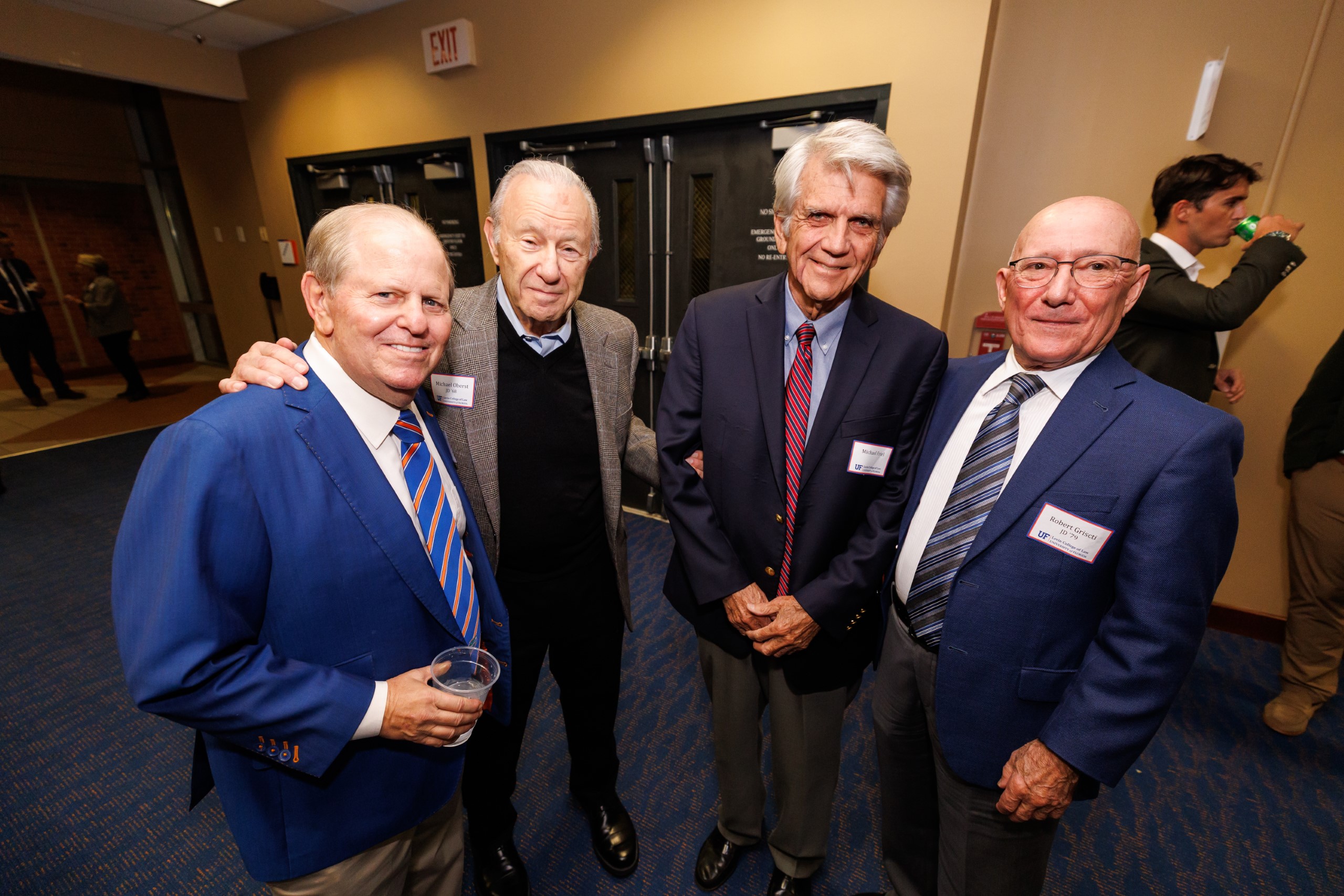 Guests pose for a photo at the celebration reception for UF Law's Professor Dennis Calfee and his 50 years of service to the law school. The celebration was held on Friday, November 15 at the University of Florida's Champions Club at Ben Hill Griffin Stadium. The reception included a welcome from Dean Merritt McAlister, and remarks from Masters of Ceremony Judge Robert Luck (JD 04), U.S. Circuit Judge, U.S. Court of Appeals for the 11th Circuit, and Judge Kathryn Kimball Mizelle (JD 12), District Judge, U.S. District Court for the Middle District of Florida. Additional guest speakers reflected on Professor Calfee's 50 year career and the impact that he has had at UF Law and beyond. After recognitions and presentations, Judge Luck and Judge Mizelle made the closing remarks.