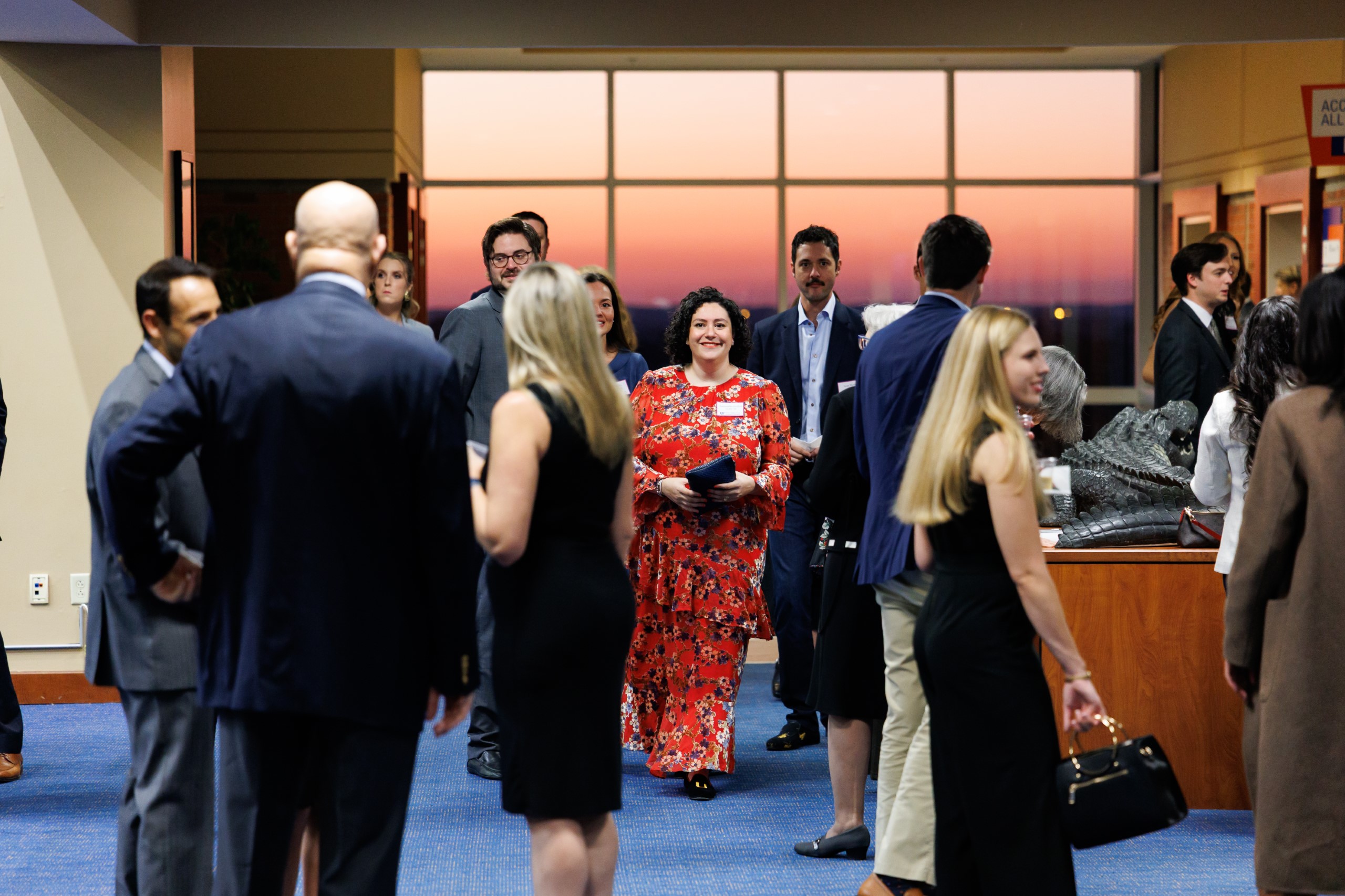 Guests mingle at the celebration reception for UF Law's Professor Dennis Calfee and his 50 years of service to the law school. The celebration was held on Friday, November 15 at the University of Florida's Champions Club at Ben Hill Griffin Stadium. The reception included a welcome from Dean Merritt McAlister, and remarks from Masters of Ceremony Judge Robert Luck (JD 04), U.S. Circuit Judge, U.S. Court of Appeals for the 11th Circuit, and Judge Kathryn Kimball Mizelle (JD 12), District Judge, U.S. District Court for the Middle District of Florida. Additional guest speakers reflected on Professor Calfee's 50 year career and the impact that he has had at UF Law and beyond. After recognitions and presentations, Judge Luck and Judge Mizelle made the closing remarks.