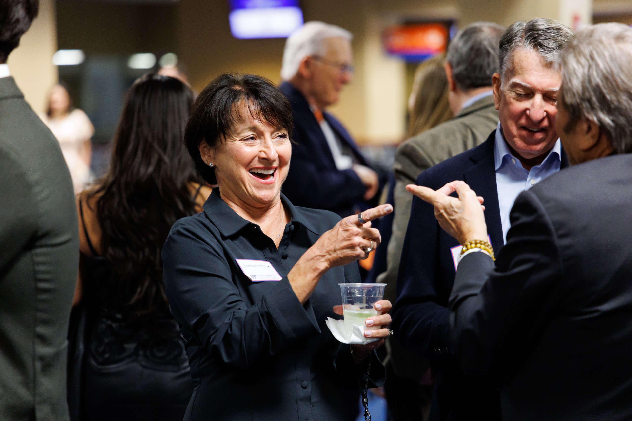 Guests mingle at the celebration reception for UF Law's Professor Dennis Calfee and his 50 years of service to the law school. The celebration was held on Friday, November 15 at the University of Florida's Champions Club at Ben Hill Griffin Stadium. The reception included a welcome from Dean Merritt McAlister, and remarks from Masters of Ceremony Judge Robert Luck (JD 04), U.S. Circuit Judge, U.S. Court of Appeals for the 11th Circuit, and Judge Kathryn Kimball Mizelle (JD 12), District Judge, U.S. District Court for the Middle District of Florida. Additional guest speakers reflected on Professor Calfee's 50 year career and the impact that he has had at UF Law and beyond. After recognitions and presentations, Judge Luck and Judge Mizelle made the closing remarks.