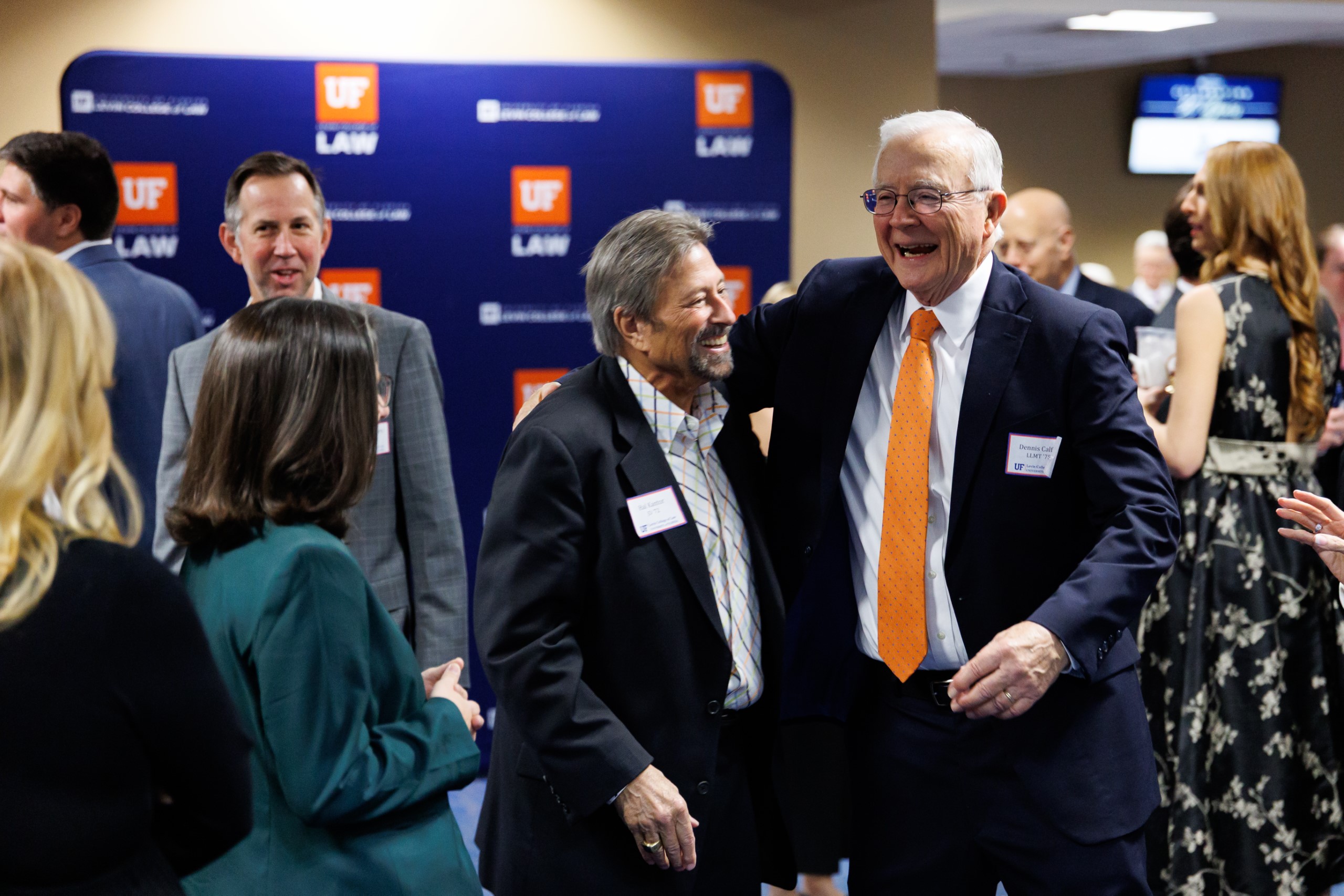 Guests mingle at the celebration reception for UF Law's Professor Dennis Calfee and his 50 years of service to the law school. The celebration was held on Friday, November 15 at the University of Florida's Champions Club at Ben Hill Griffin Stadium. The reception included a welcome from Dean Merritt McAlister, and remarks from Masters of Ceremony Judge Robert Luck (JD 04), U.S. Circuit Judge, U.S. Court of Appeals for the 11th Circuit, and Judge Kathryn Kimball Mizelle (JD 12), District Judge, U.S. District Court for the Middle District of Florida. Additional guest speakers reflected on Professor Calfee's 50 year career and the impact that he has had at UF Law and beyond. After recognitions and presentations, Judge Luck and Judge Mizelle made the closing remarks.