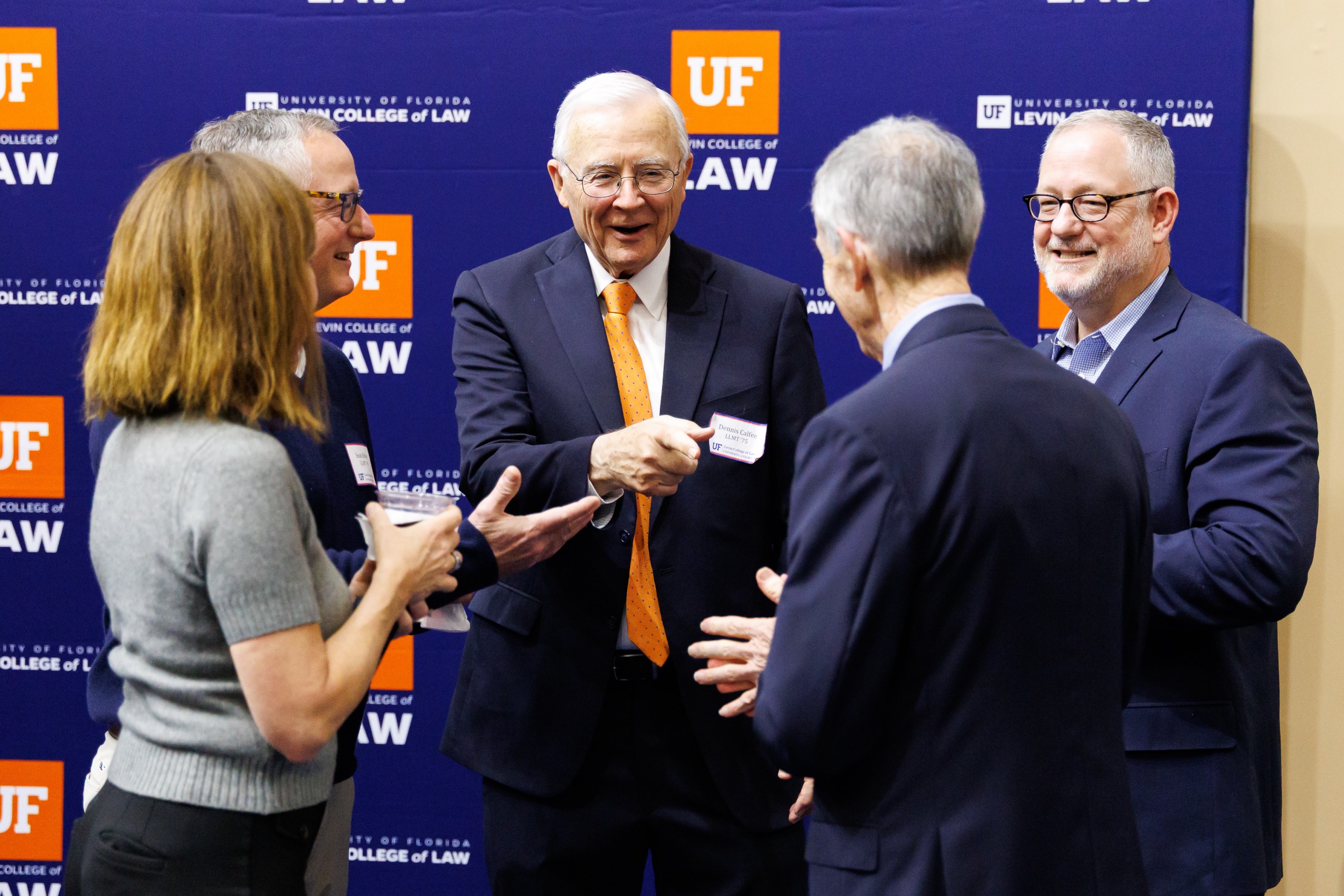 Guests mingle at the celebration reception for UF Law's Professor Dennis Calfee and his 50 years of service to the law school. The celebration was held on Friday, November 15 at the University of Florida's Champions Club at Ben Hill Griffin Stadium. The reception included a welcome from Dean Merritt McAlister, and remarks from Masters of Ceremony Judge Robert Luck (JD 04), U.S. Circuit Judge, U.S. Court of Appeals for the 11th Circuit, and Judge Kathryn Kimball Mizelle (JD 12), District Judge, U.S. District Court for the Middle District of Florida. Additional guest speakers reflected on Professor Calfee's 50 year career and the impact that he has had at UF Law and beyond. After recognitions and presentations, Judge Luck and Judge Mizelle made the closing remarks.