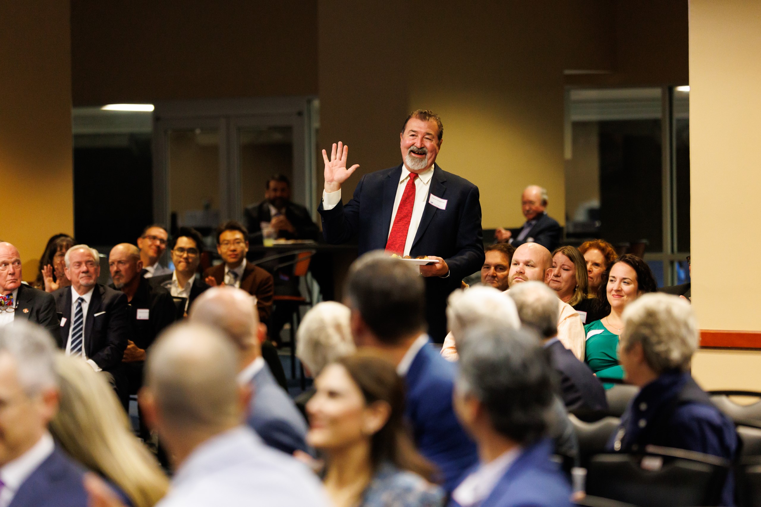 Guest speakers address the audience at the celebration reception for UF Law's Professor Dennis Calfee and his 50 years of service to the law school. The celebration was held on Friday, November 15 at the University of Florida's Champions Club at Ben Hill Griffin Stadium. The reception included a welcome from Dean Merritt McAlister, and remarks from Masters of Ceremony Judge Robert Luck (JD 04), U.S. Circuit Judge, U.S. Court of Appeals for the 11th Circuit, and Judge Kathryn Kimball Mizelle (JD 12), District Judge, U.S. District Court for the Middle District of Florida. Additional guest speakers reflected on Professor Calfee's 50 year career and the impact that he has had at UF Law and beyond. After recognitions and presentations, Judge Luck and Judge Mizelle made the closing remarks.