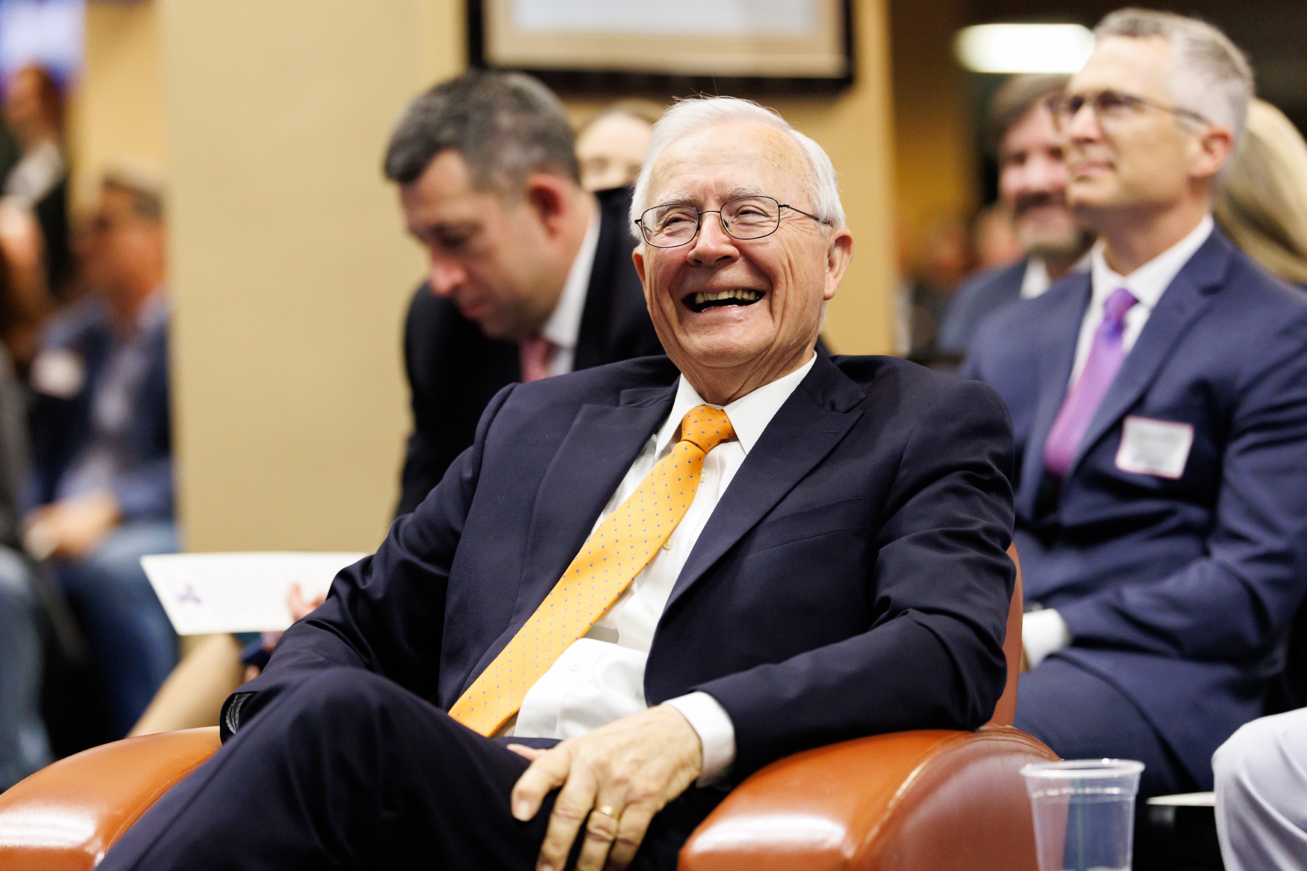 Guests smile as they listen to the speakers at the celebration reception for UF Law's Professor Dennis Calfee and his 50 years of service to the law school. The celebration was held on Friday, November 15 at the University of Florida's Champions Club at Ben Hill Griffin Stadium. The reception included a welcome from Dean Merritt McAlister, and remarks from Masters of Ceremony Judge Robert Luck (JD 04), U.S. Circuit Judge, U.S. Court of Appeals for the 11th Circuit, and Judge Kathryn Kimball Mizelle (JD 12), District Judge, U.S. District Court for the Middle District of Florida. Additional guest speakers reflected on Professor Calfee's 50 year career and the impact that he has had at UF Law and beyond. After recognitions and presentations, Judge Luck and Judge Mizelle made the closing remarks.