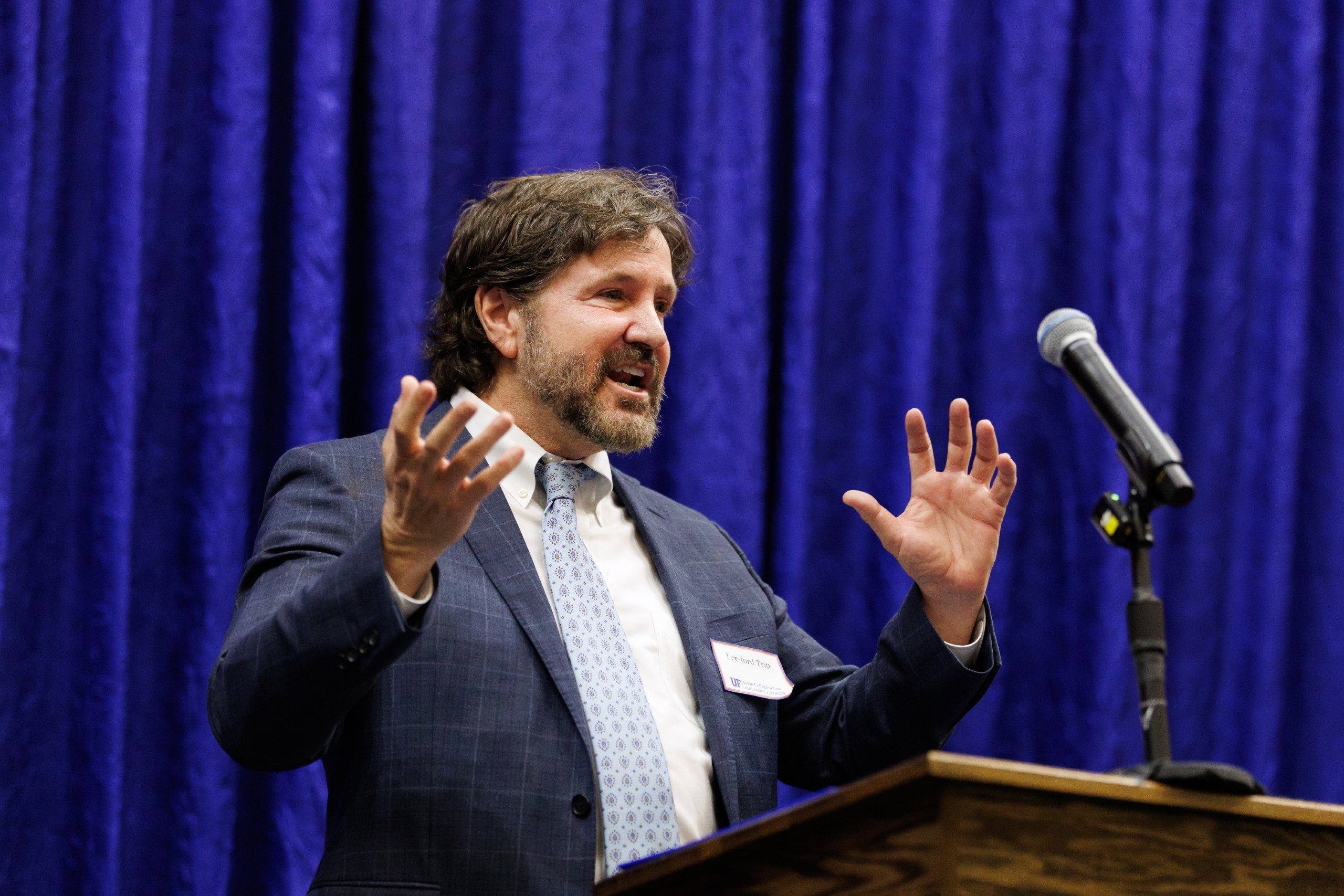 Guest speakers address the audience at the celebration reception for UF Law's Professor Dennis Calfee and his 50 years of service to the law school. The celebration was held on Friday, November 15 at the University of Florida's Champions Club at Ben Hill Griffin Stadium. The reception included a welcome from Dean Merritt McAlister, and remarks from Masters of Ceremony Judge Robert Luck (JD 04), U.S. Circuit Judge, U.S. Court of Appeals for the 11th Circuit, and Judge Kathryn Kimball Mizelle (JD 12), District Judge, U.S. District Court for the Middle District of Florida. Additional guest speakers reflected on Professor Calfee's 50 year career and the impact that he has had at UF Law and beyond. After recognitions and presentations, Judge Luck and Judge Mizelle made the closing remarks.