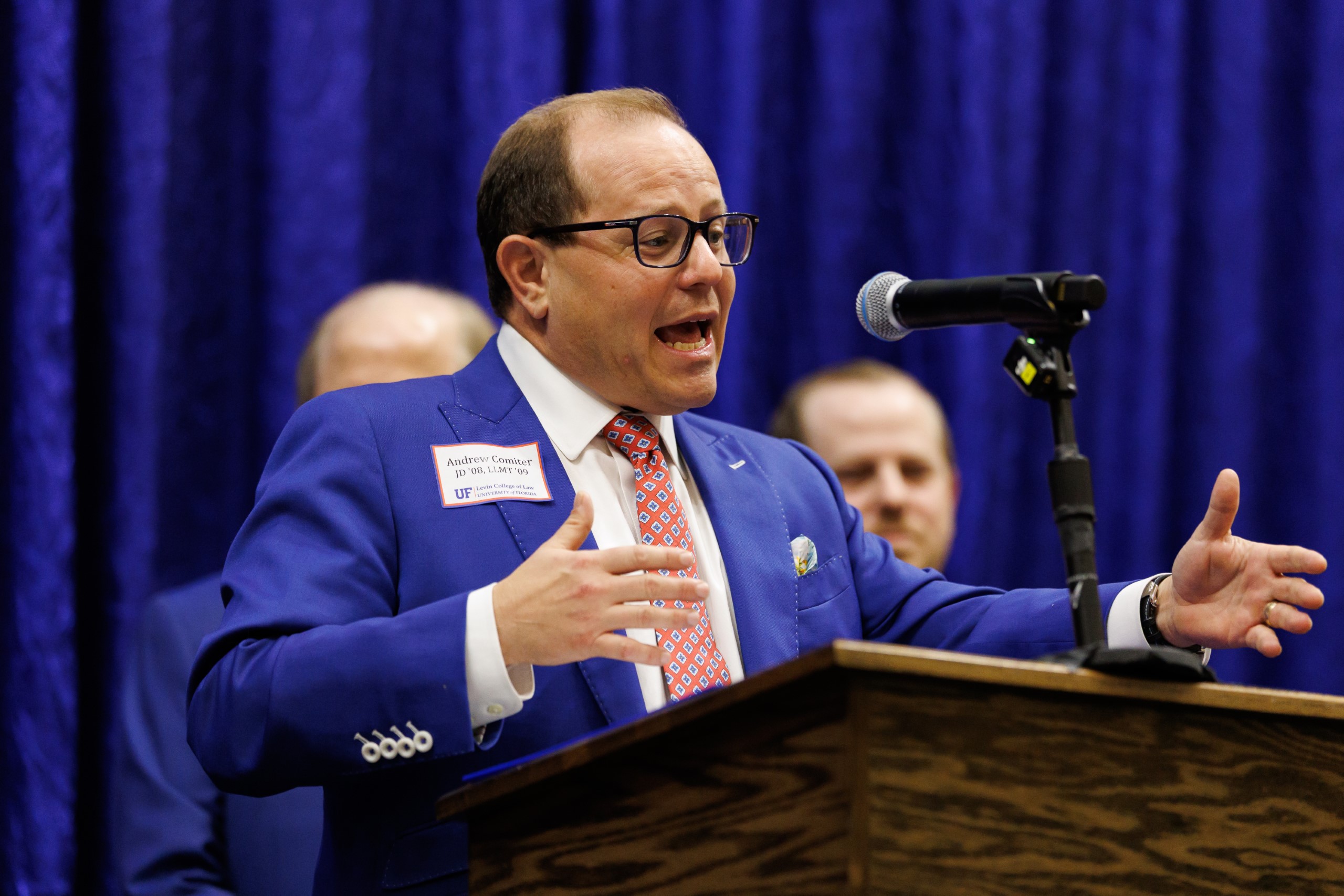 Guest speakers address the audience at the celebration reception for UF Law's Professor Dennis Calfee and his 50 years of service to the law school. The celebration was held on Friday, November 15 at the University of Florida's Champions Club at Ben Hill Griffin Stadium. The reception included a welcome from Dean Merritt McAlister, and remarks from Masters of Ceremony Judge Robert Luck (JD 04), U.S. Circuit Judge, U.S. Court of Appeals for the 11th Circuit, and Judge Kathryn Kimball Mizelle (JD 12), District Judge, U.S. District Court for the Middle District of Florida. Additional guest speakers reflected on Professor Calfee's 50 year career and the impact that he has had at UF Law and beyond. After recognitions and presentations, Judge Luck and Judge Mizelle made the closing remarks.