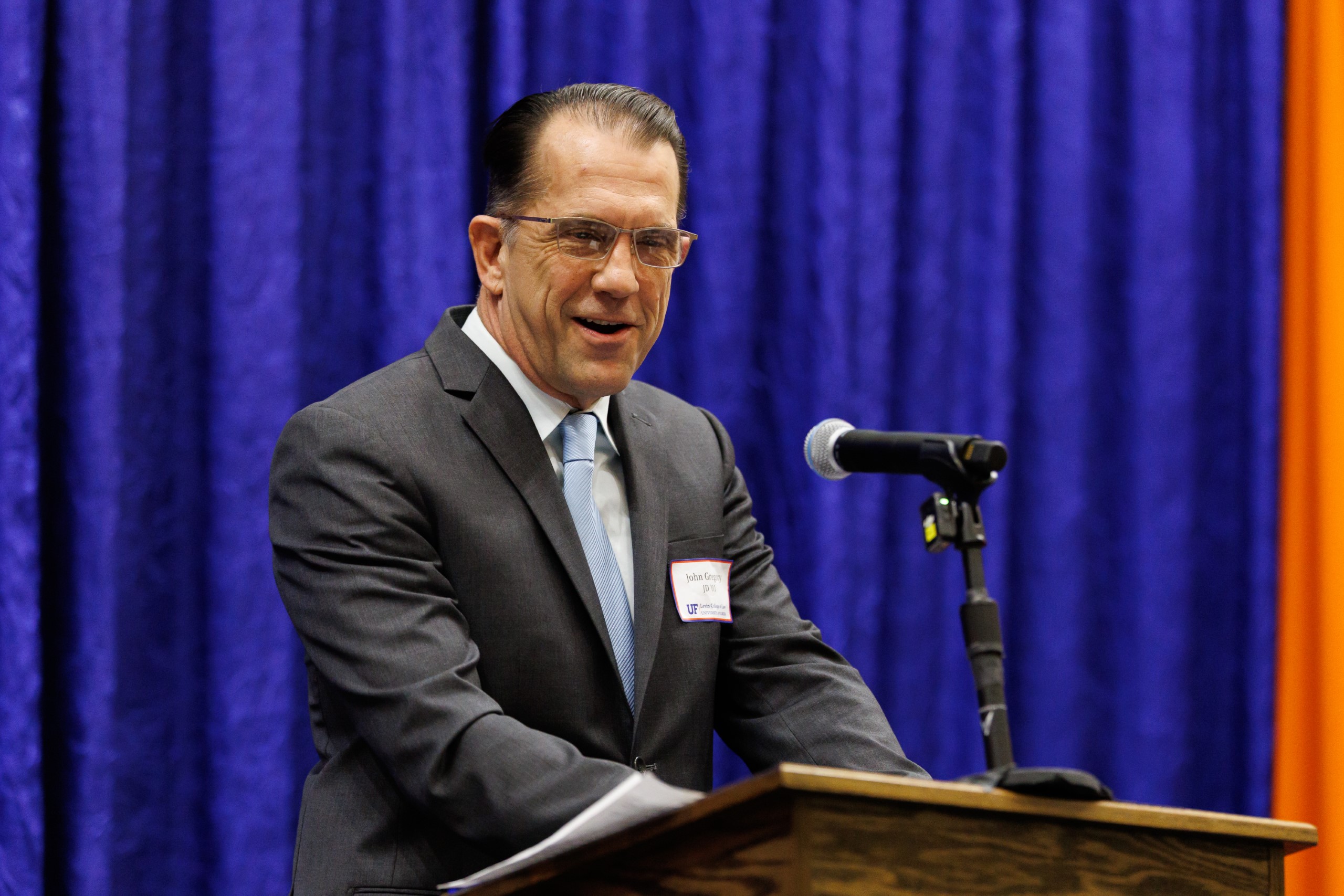 Guest speakers address the audience at the celebration reception for UF Law's Professor Dennis Calfee and his 50 years of service to the law school. The celebration was held on Friday, November 15 at the University of Florida's Champions Club at Ben Hill Griffin Stadium. The reception included a welcome from Dean Merritt McAlister, and remarks from Masters of Ceremony Judge Robert Luck (JD 04), U.S. Circuit Judge, U.S. Court of Appeals for the 11th Circuit, and Judge Kathryn Kimball Mizelle (JD 12), District Judge, U.S. District Court for the Middle District of Florida. Additional guest speakers reflected on Professor Calfee's 50 year career and the impact that he has had at UF Law and beyond. After recognitions and presentations, Judge Luck and Judge Mizelle made the closing remarks.