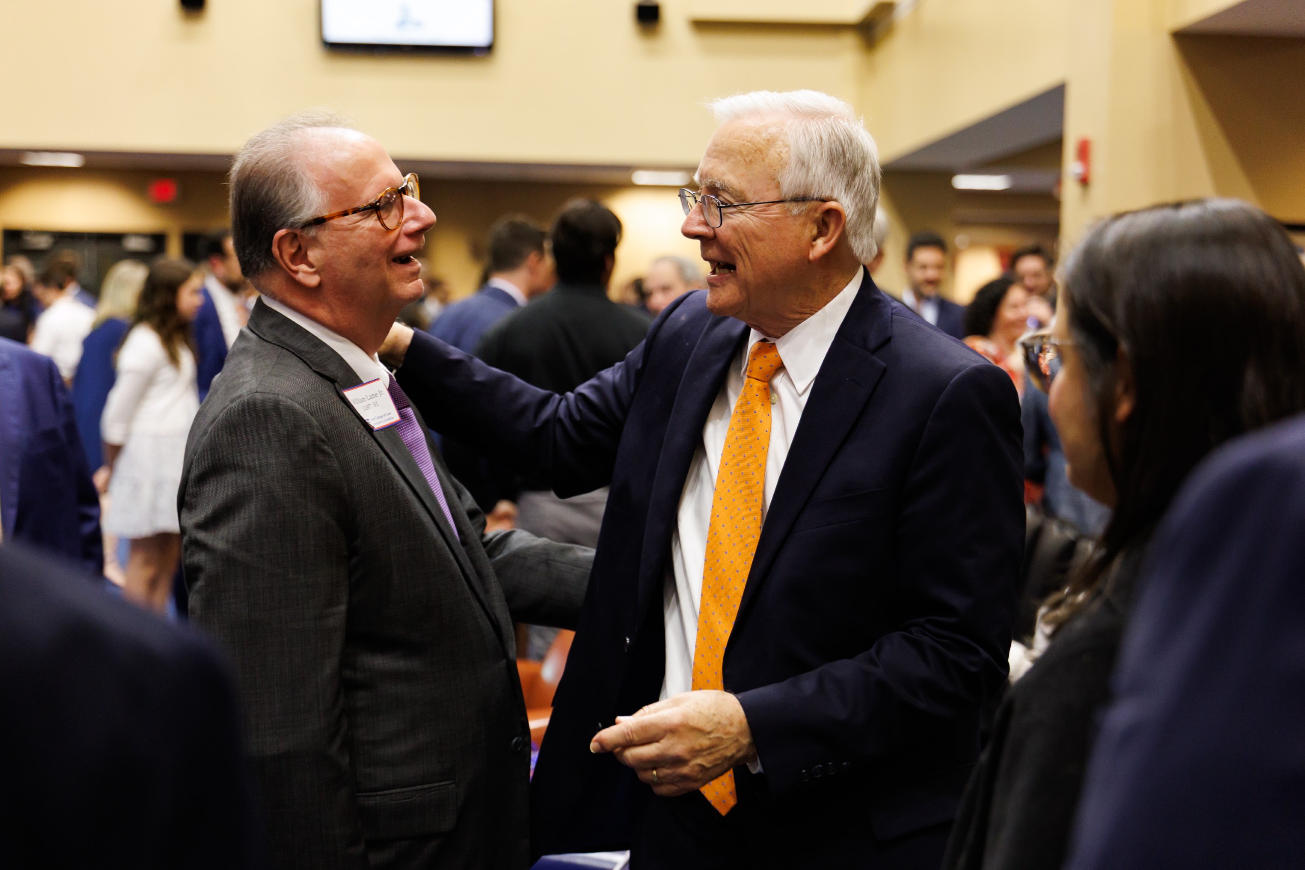 UF Law Professor Dennis Calfee talks to guests at his celebration reception for his 50 years of service to the law school. The celebration was held on Friday, November 15 at the University of Florida's Champions Club at Ben Hill Griffin Stadium. The reception included a welcome from Dean Merritt McAlister, and remarks from Masters of Ceremony Judge Robert Luck (JD 04), U.S. Circuit Judge, U.S. Court of Appeals for the 11th Circuit, and Judge Kathryn Kimball Mizelle (JD 12), District Judge, U.S. District Court for the Middle District of Florida. Additional guest speakers reflected on Professor Calfee's 50 year career and the impact that he has had at UF Law and beyond. After recognitions and presentations, Judge Luck and Judge Mizelle made the closing remarks.