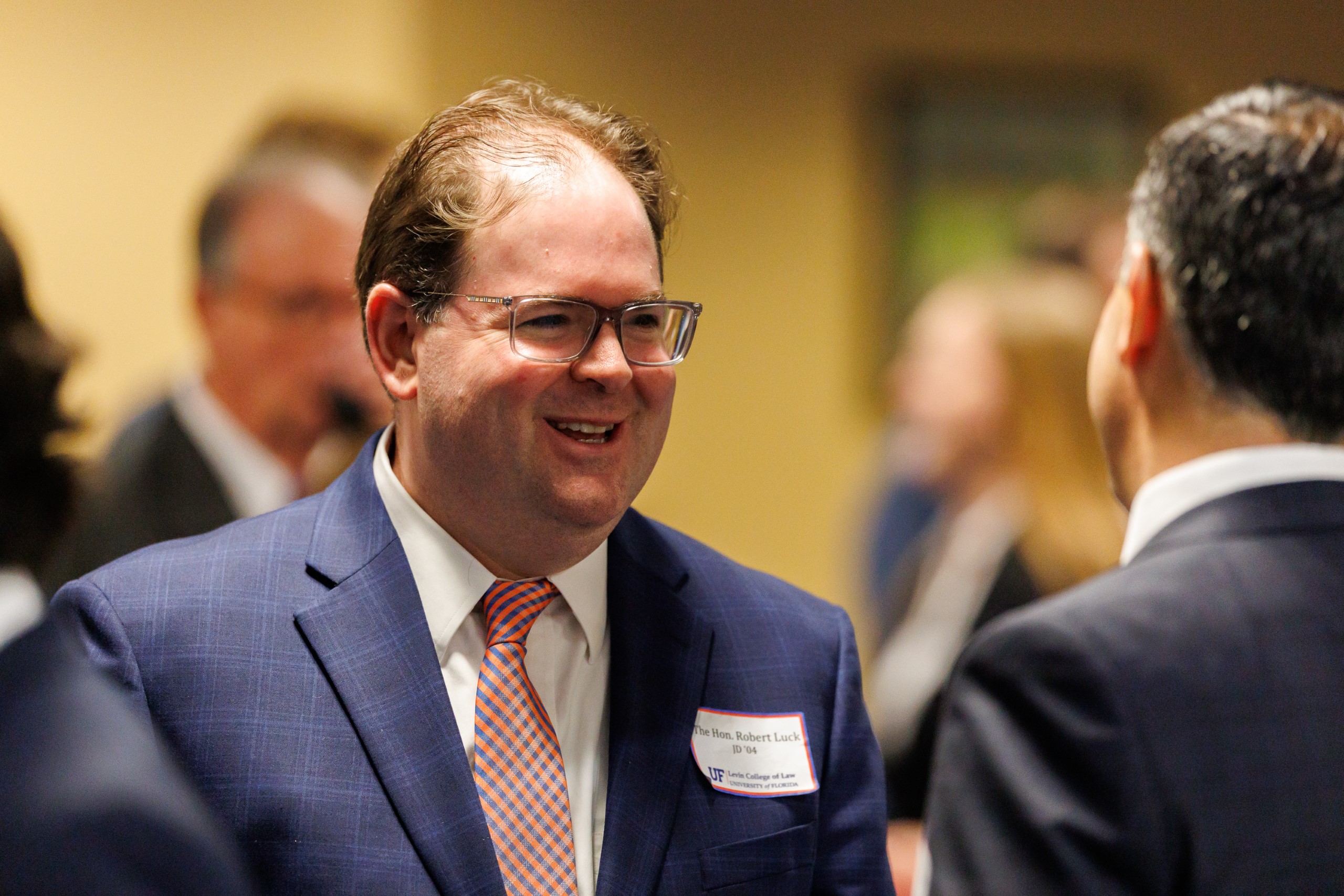 Judge Robert Luck (JD 04), U.S. Circuit Judge, U.S. Court of Appeals for the 11th Circuit, smiles as he speaks to guests at the celebration reception for UF Law's Professor Dennis Calfee and his 50 years of service to the law school. Judge Luck and Judge Kathryn Kimball Mizelle (JD 12), District Judge, U.S. District Court for the Middle District of Florida, served as the Masters of Ceremony at the Friday, November 15 event.