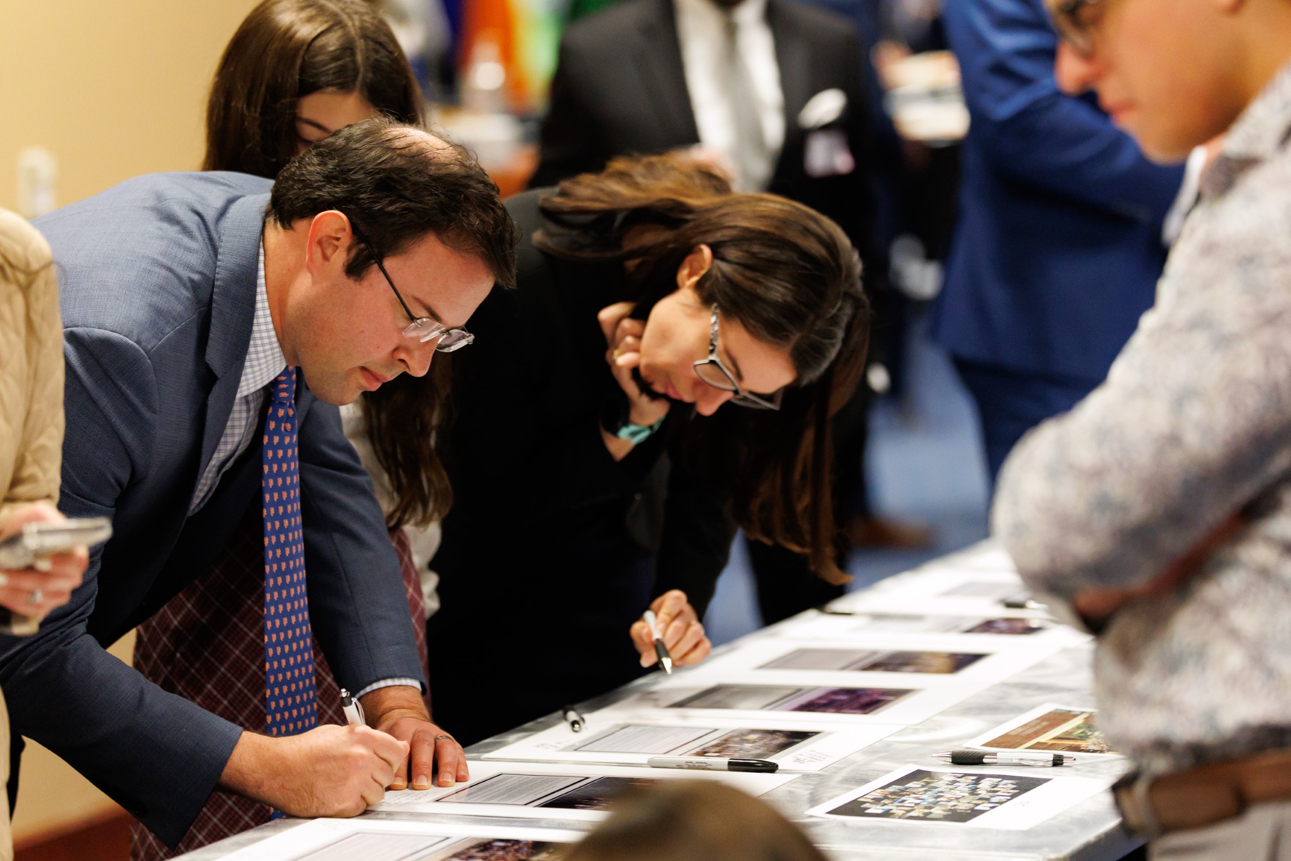 Guests mingle at the celebration reception for UF Law's Professor Dennis Calfee and his 50 years of service to the law school. The celebration was held on Friday, November 15 at the University of Florida's Champions Club at Ben Hill Griffin Stadium. The reception included a welcome from Dean Merritt McAlister, and remarks from Masters of Ceremony Judge Robert Luck (JD 04), U.S. Circuit Judge, U.S. Court of Appeals for the 11th Circuit, and Judge Kathryn Kimball Mizelle (JD 12), District Judge, U.S. District Court for the Middle District of Florida. Additional guest speakers reflected on Professor Calfee's 50 year career and the impact that he has had at UF Law and beyond. After recognitions and presentations, Judge Luck and Judge Mizelle made the closing remarks.