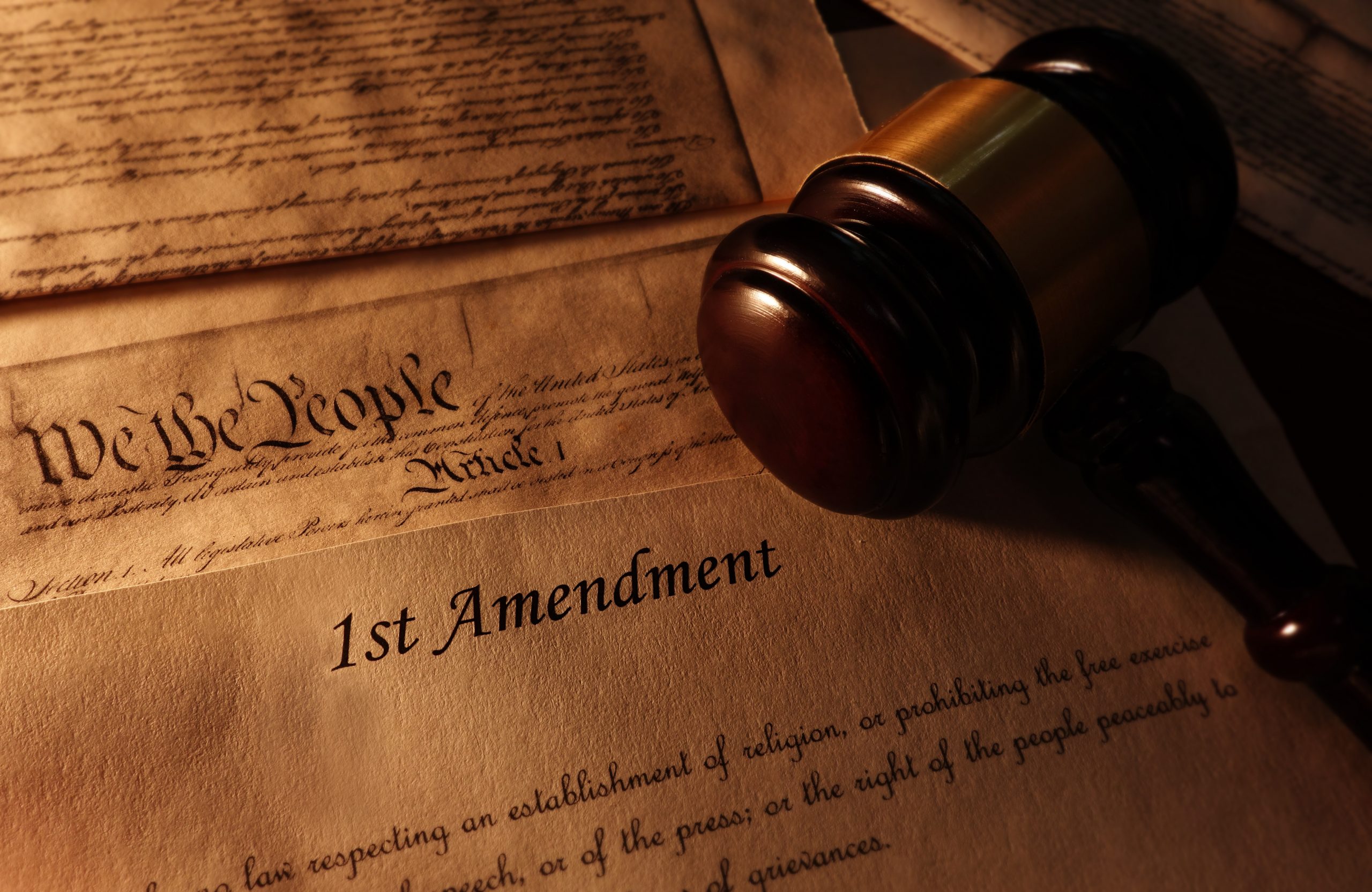 A gavel laying on a copy of the U.S. Constitution.